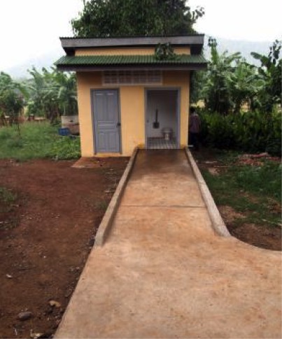 A wash room facility accessed by a path and ramp leading to the entrance